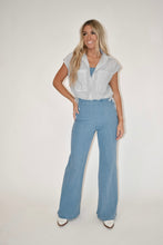 Load image into Gallery viewer, Women&#39;s clothing boutique, online women&#39;s clothing boutique, model is modeling the light wash denim jumpsuit with a stripe tank top over it, spring outfit, summer outfit 
